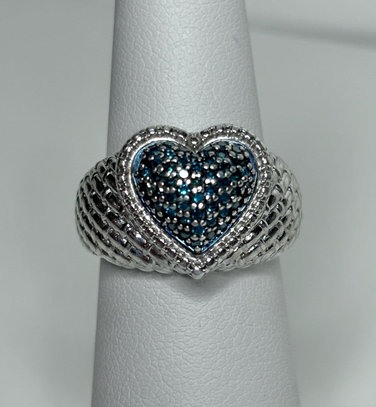Sterling silver heart ring with pave blue diamonds.