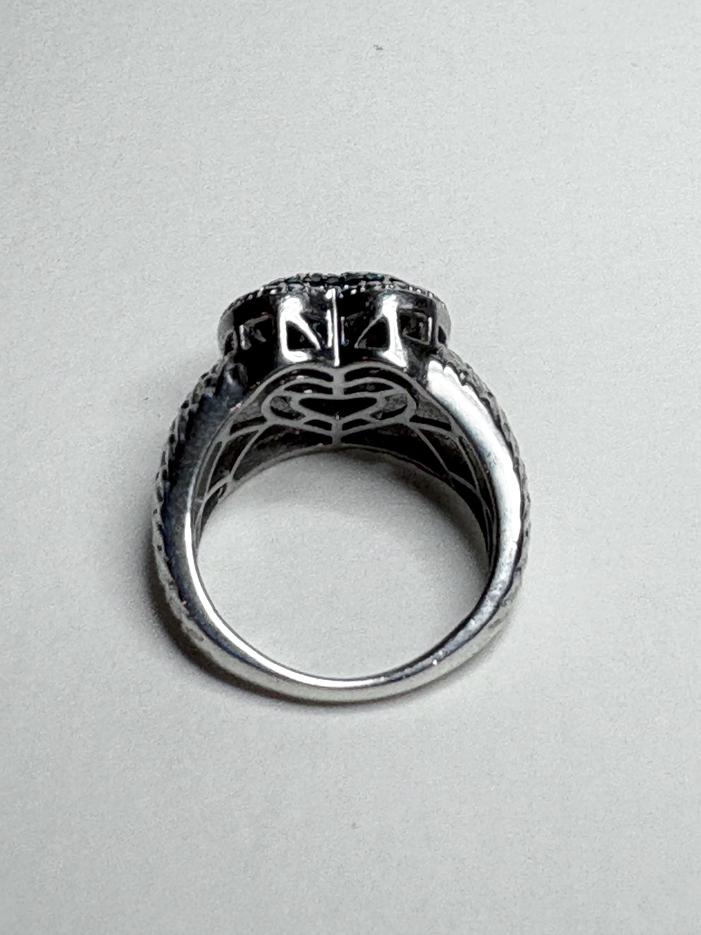 Sterling silver ring with pave blue diamonds in a heart shape.