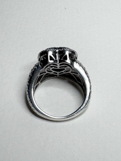 Sterling silver ring with pave blue diamonds in a heart shape.