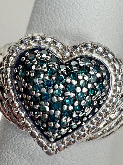 Sterling silver ring with a pave blue diamond heart design.