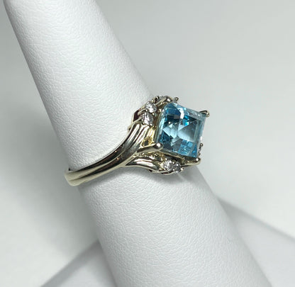 14k gold ring with a blue topaz and diamonds.