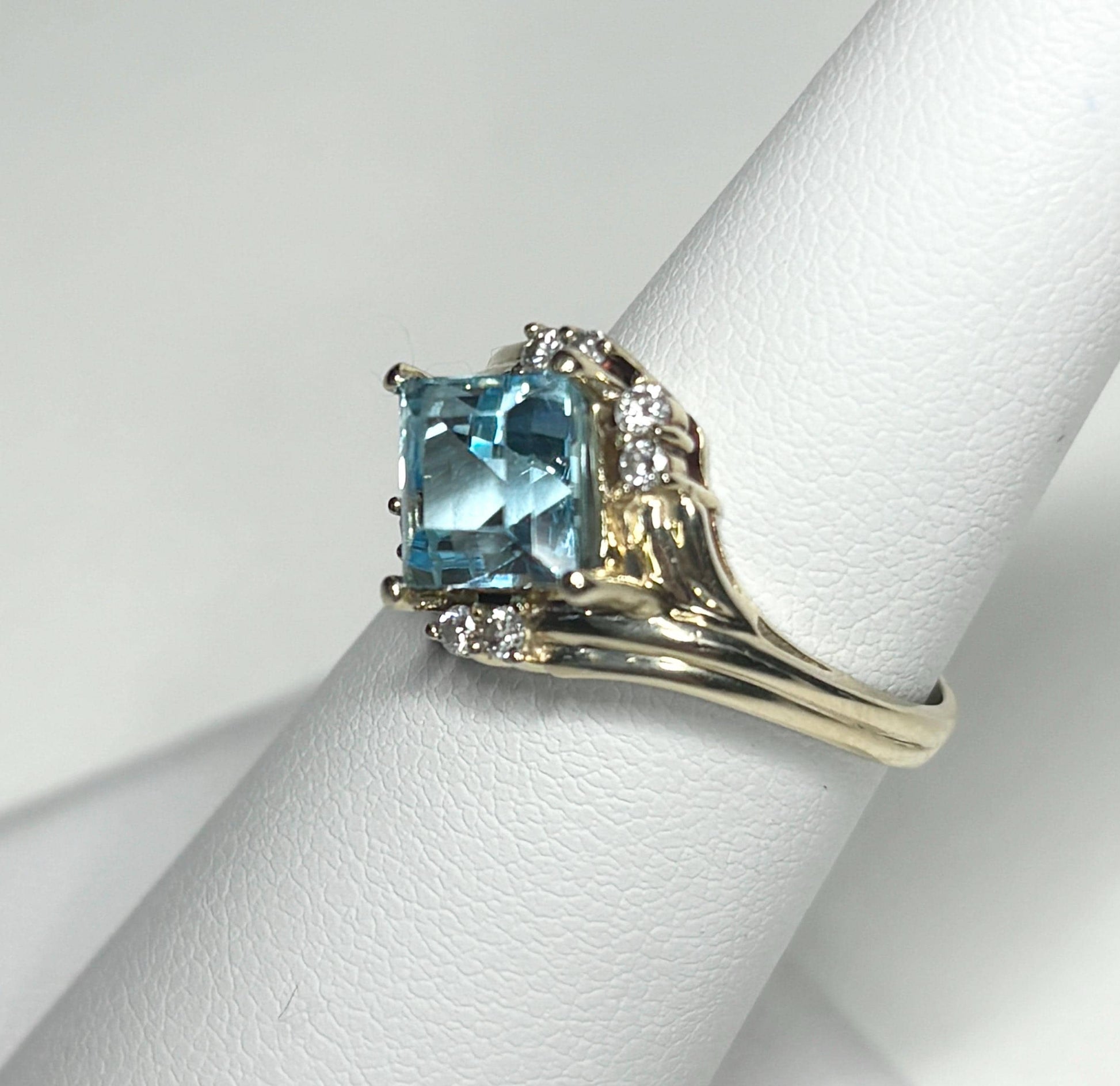Fancy rhombus sky blue topaz and diamond ring in solid 14k gold.
