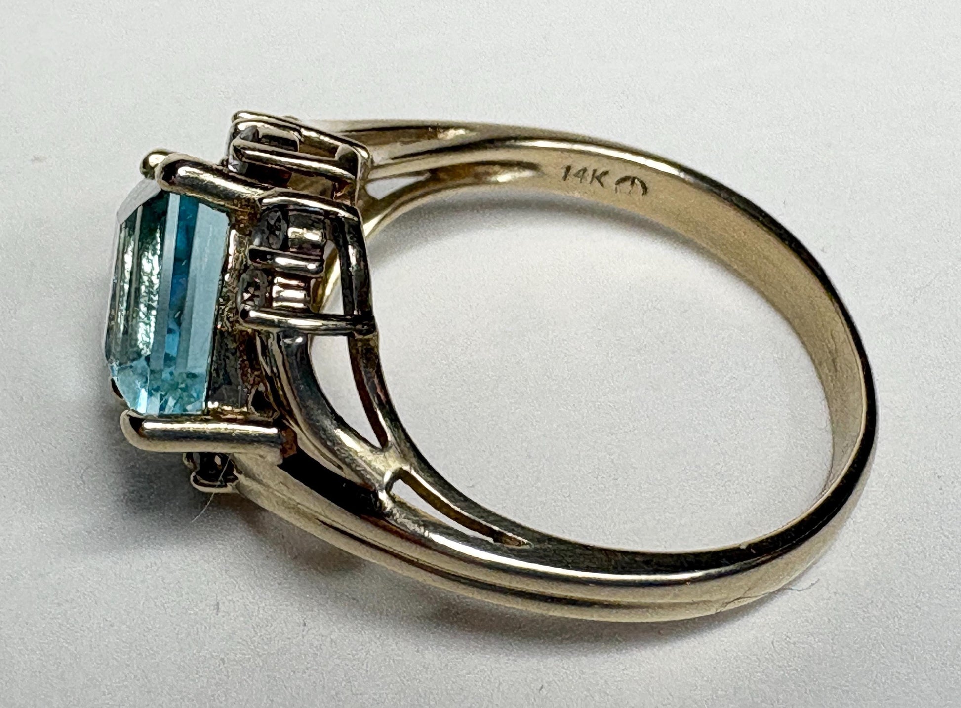 14k gold ring with a rhombus-cut blue topaz and diamonds.