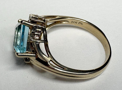 14k gold ring with a rhombus-cut blue topaz and diamonds.