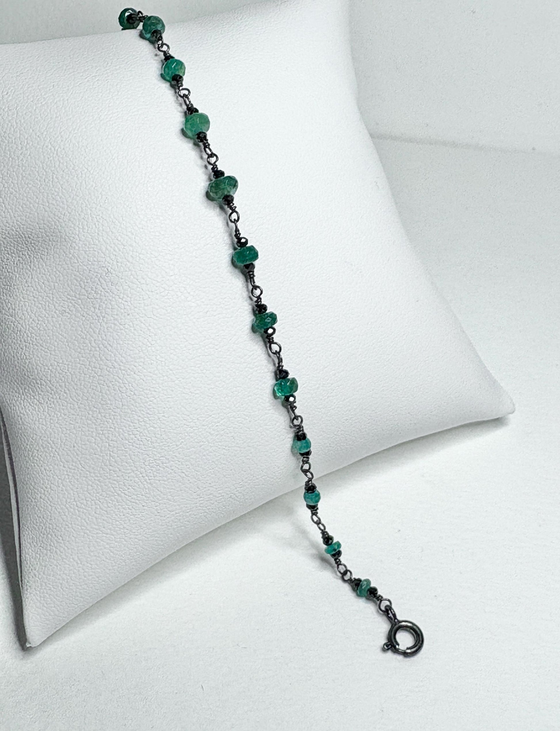 Oxidized sterling silver bracelet with natural emeralds and black diamond beads.