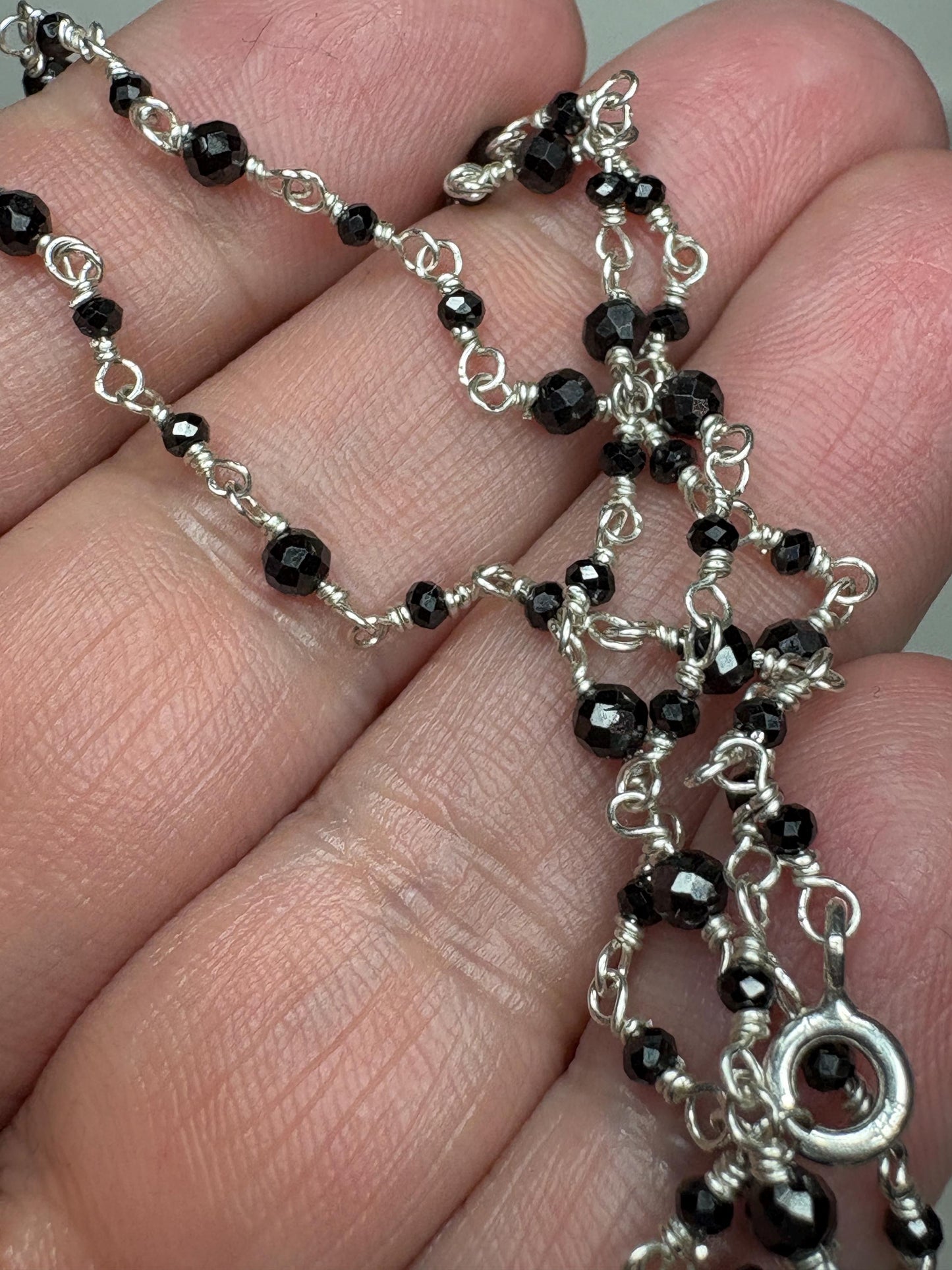 Sterling silver necklace with faceted black diamond beads.