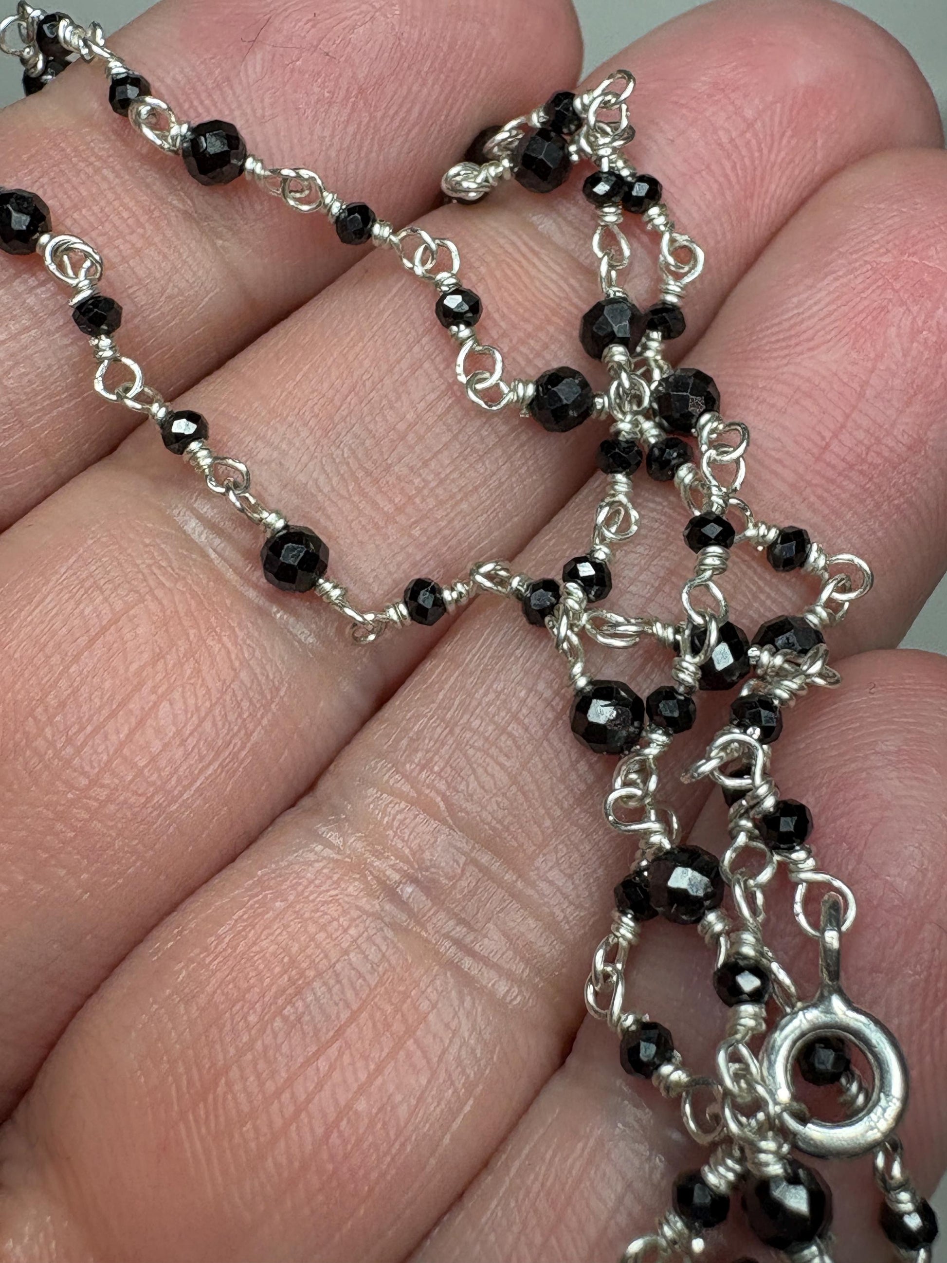 Sterling silver necklace with faceted black diamond beads.