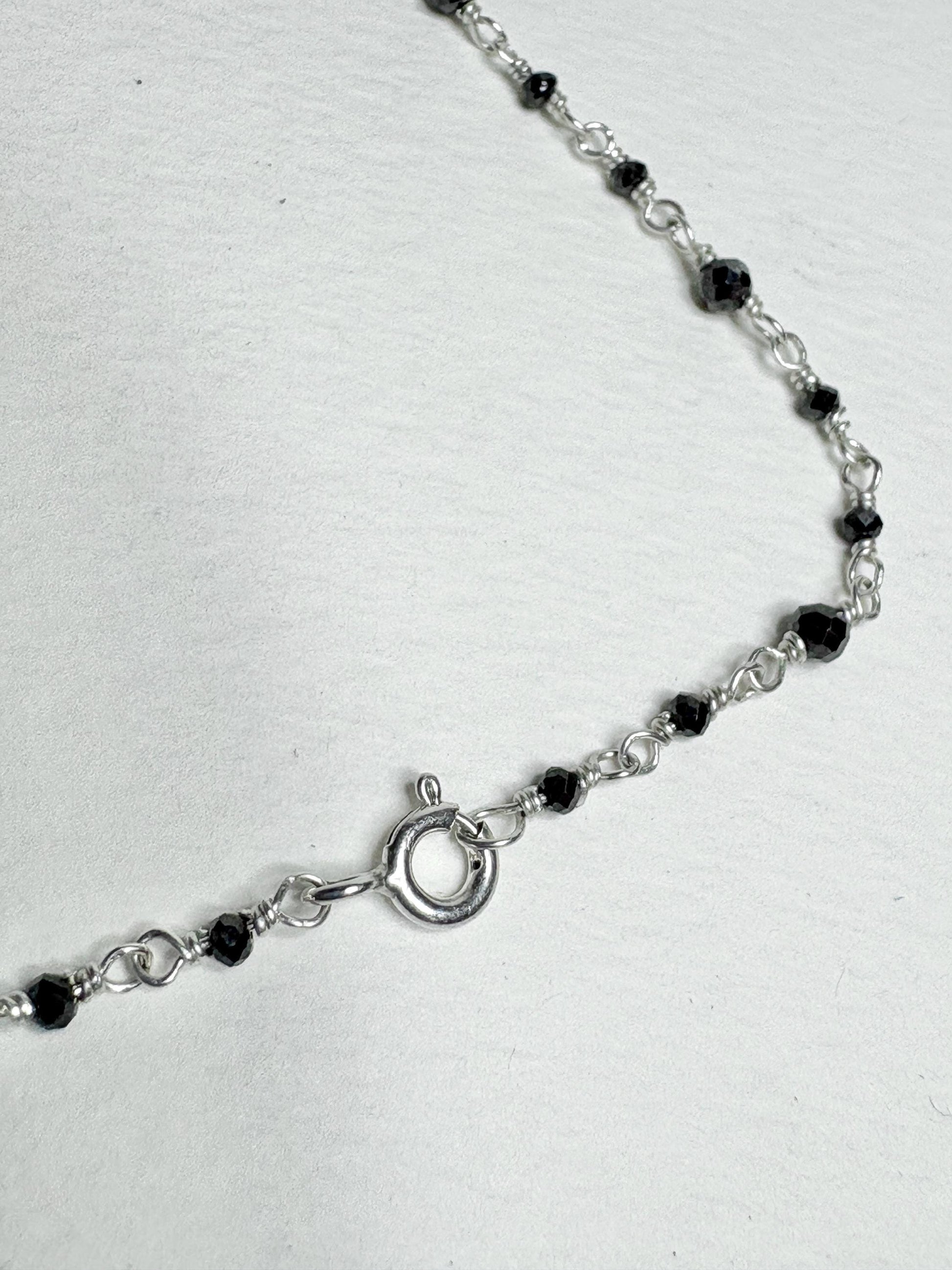 Sterling silver necklace with black diamond beads and a lobster clasp.