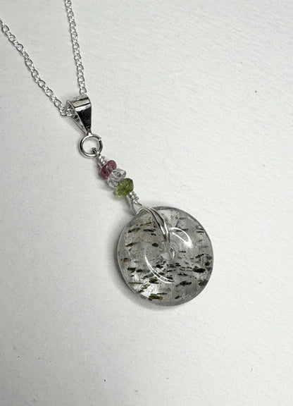 Sterling silver necklace with a tourmalated quartz donut pendant and beaded accents.