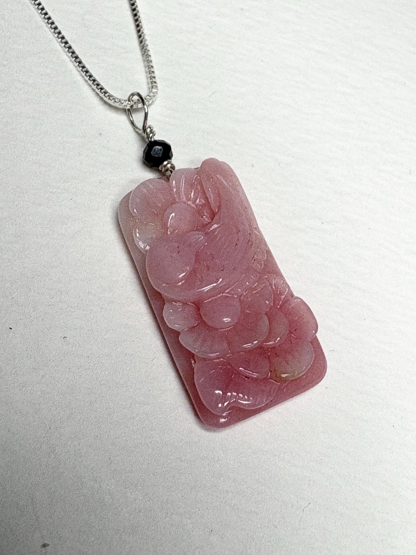 Peruvian pink opal pendant with carved dove and blossoms on a sterling silver chain.