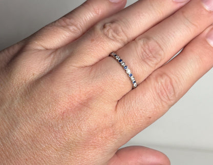 A 14k white gold band ring with alternating blue sapphires and diamonds in a honeycomb hexagon pattern.