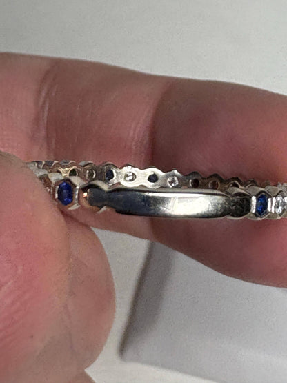 14k white gold band with blue sapphires and diamonds.