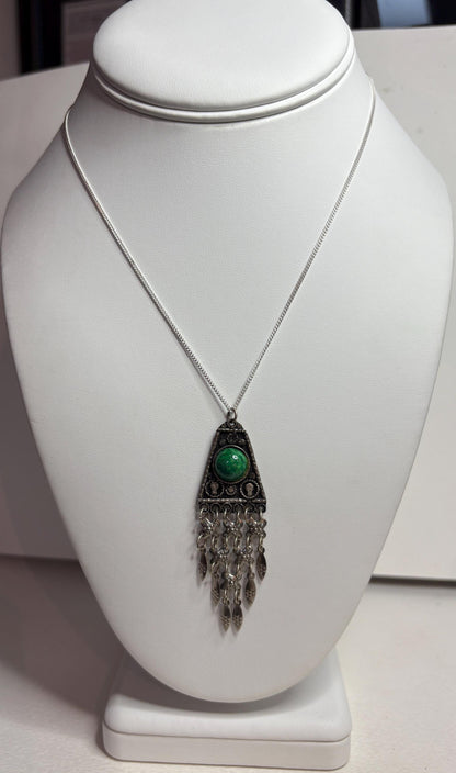 Sterling silver pendant with green stone and fringe detail.