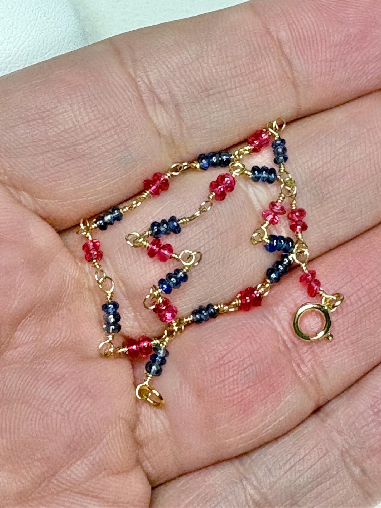 Dainty 14k gold bracelet with smooth Burmese sapphire and red spinel beads.