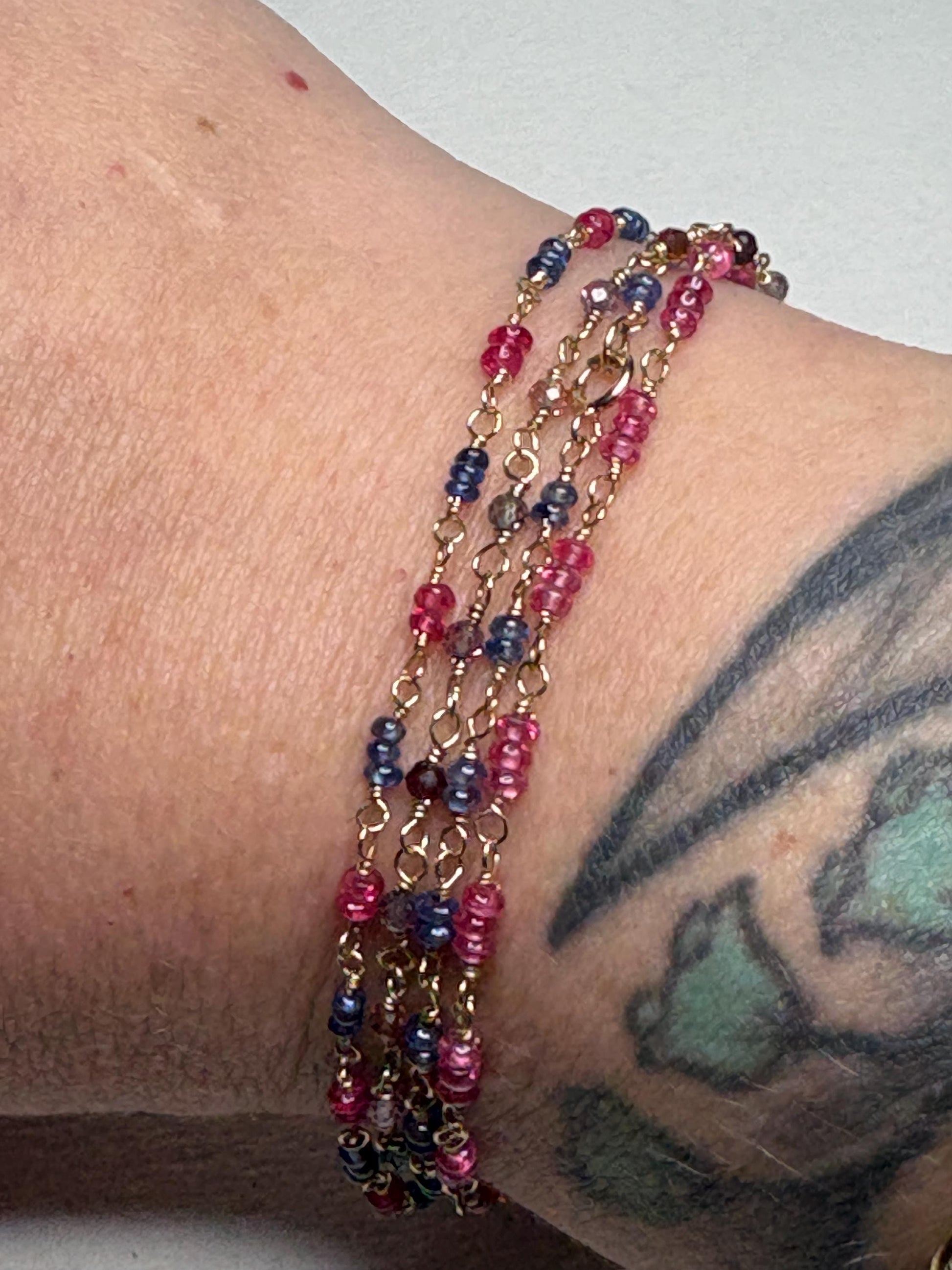 Dainty bracelet with smooth sapphire and spinel beads on 14k gold.