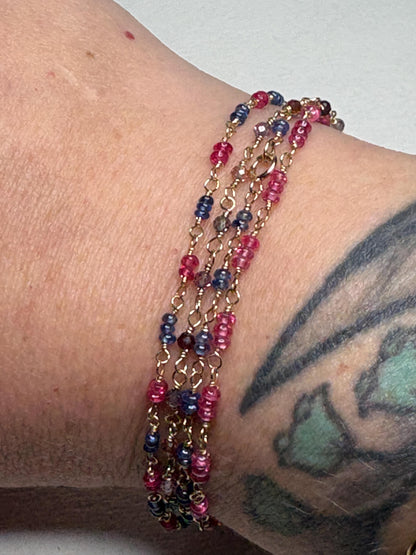Dainty bracelet with smooth sapphire and spinel beads on 14k gold.