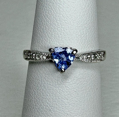Heart-shaped tanzanite ring with diamonds on a white gold band.