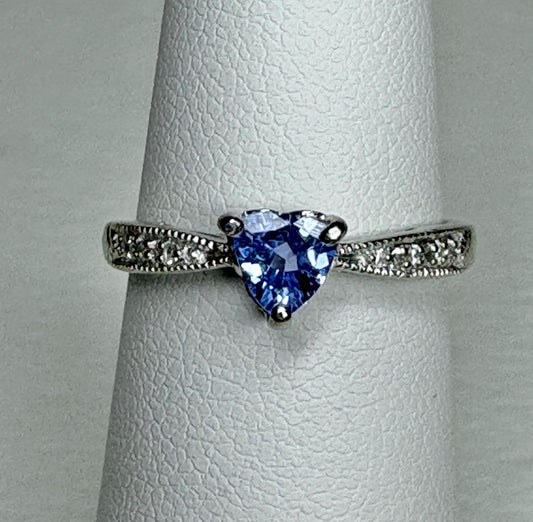 Heart-shaped tanzanite ring with diamonds on a white gold band.