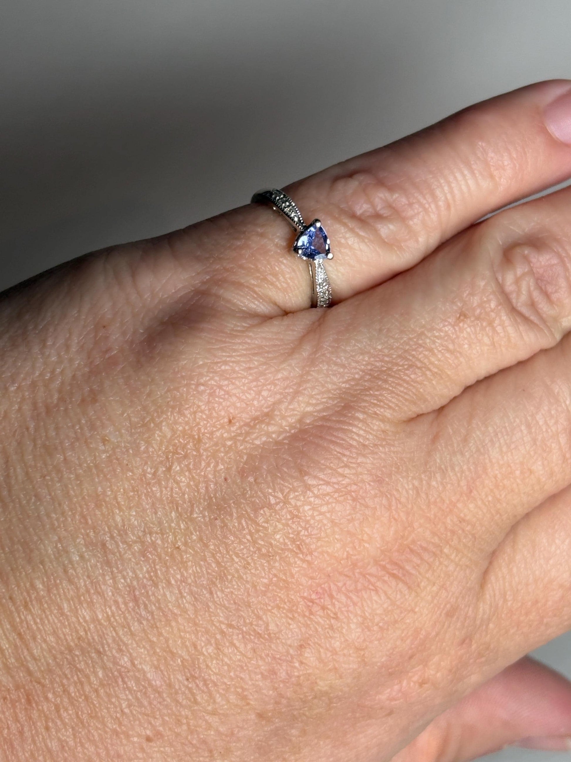 Tanzanite trillion heart ring with diamonds in 10k white gold.