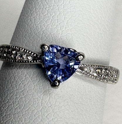 Tanzanite trillion ring with diamonds on a white gold band.