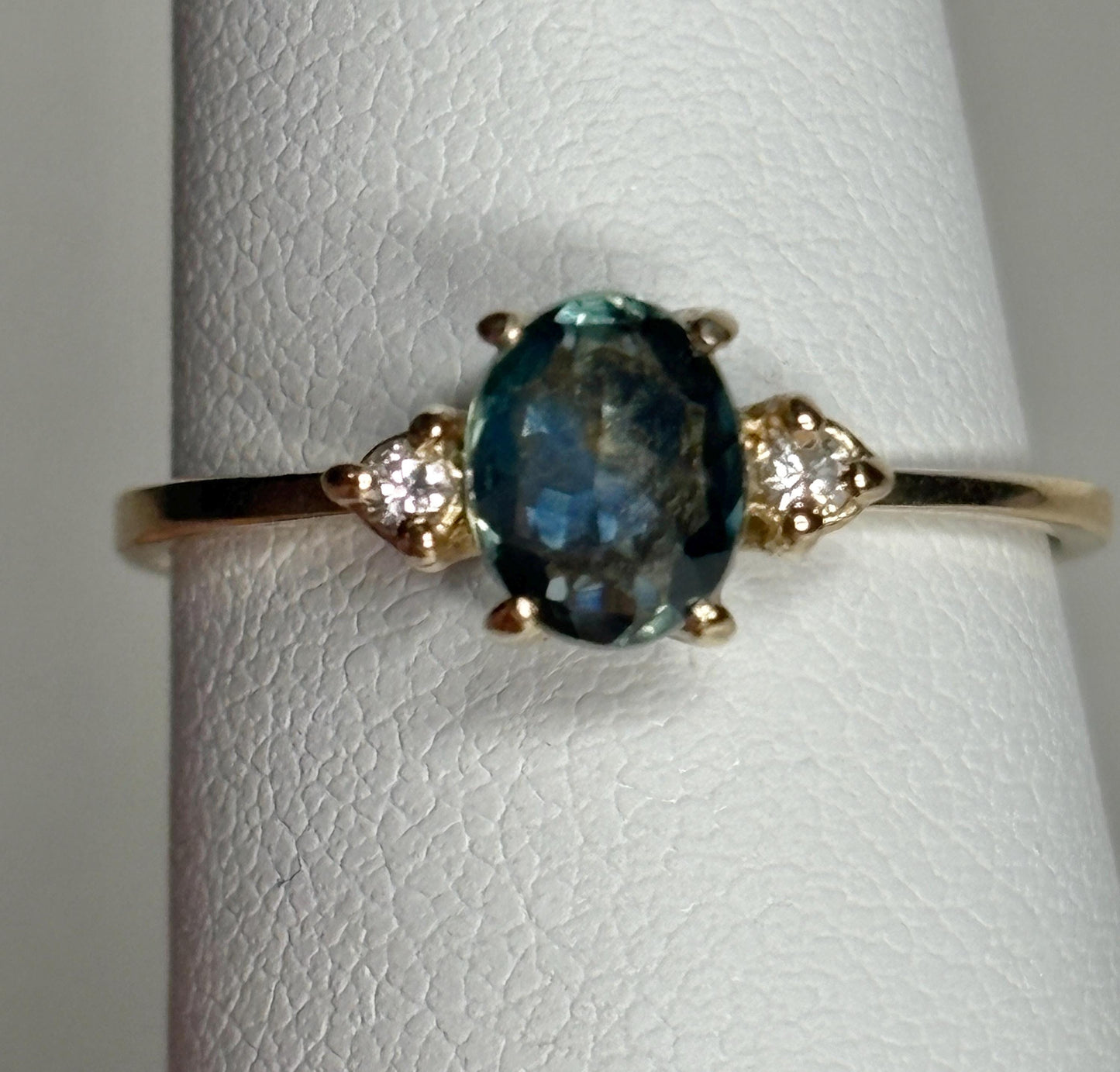 Oval Montana sapphire and diamond ring in 14k yellow gold.