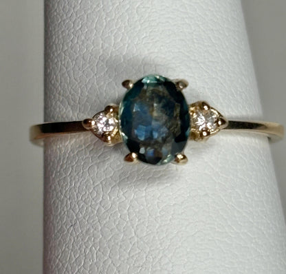Oval Montana sapphire and diamond ring in 14k yellow gold.