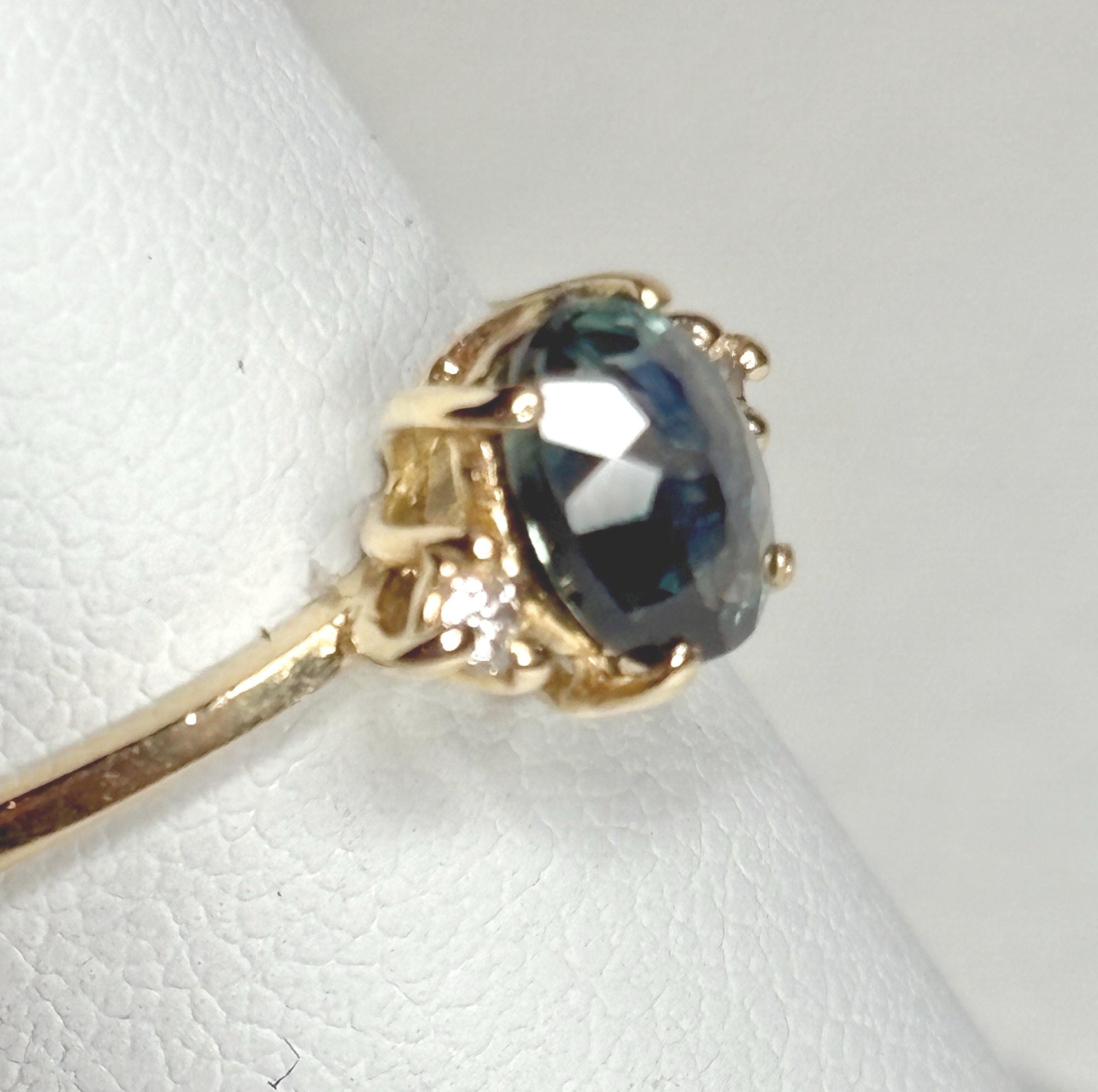 Oval Montana sapphire and diamond ring in 14k yellow gold.
