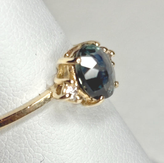 Oval Montana sapphire and diamond ring in 14k yellow gold.