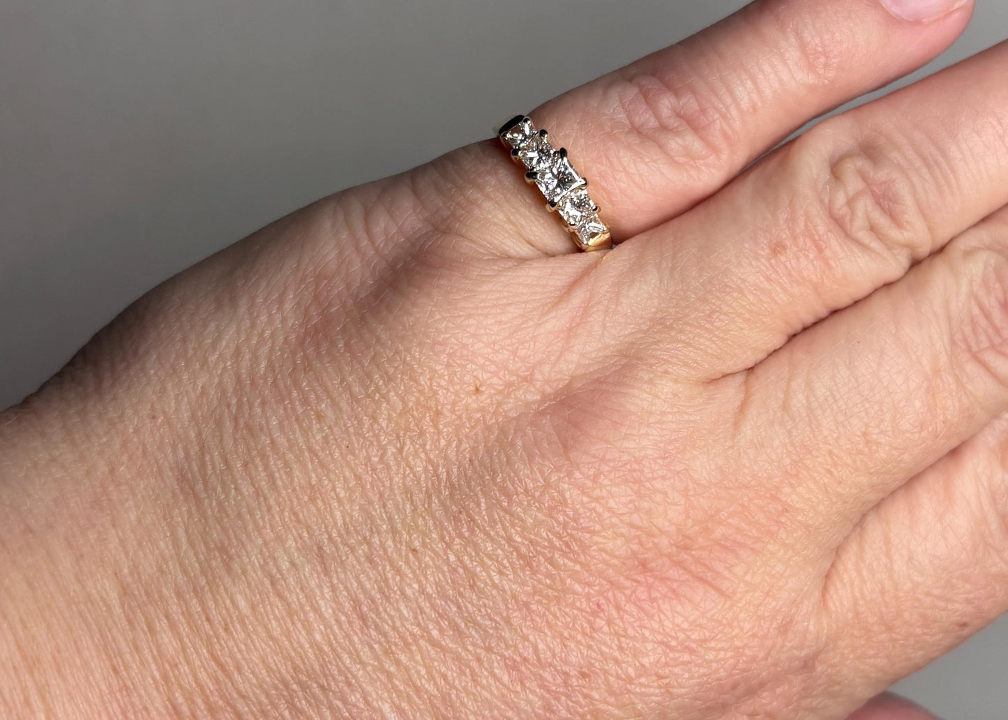 14k gold anniversary band with five princess-cut diamonds.