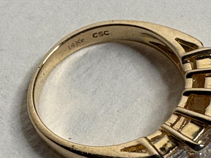 14k gold band ring with "14Kr CSC" inscription.