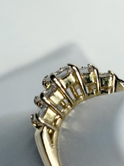 A 14k yellow gold band ring with five princess-cut diamonds.