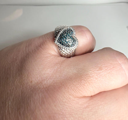 Sterling silver heart ring with pave blue diamonds.