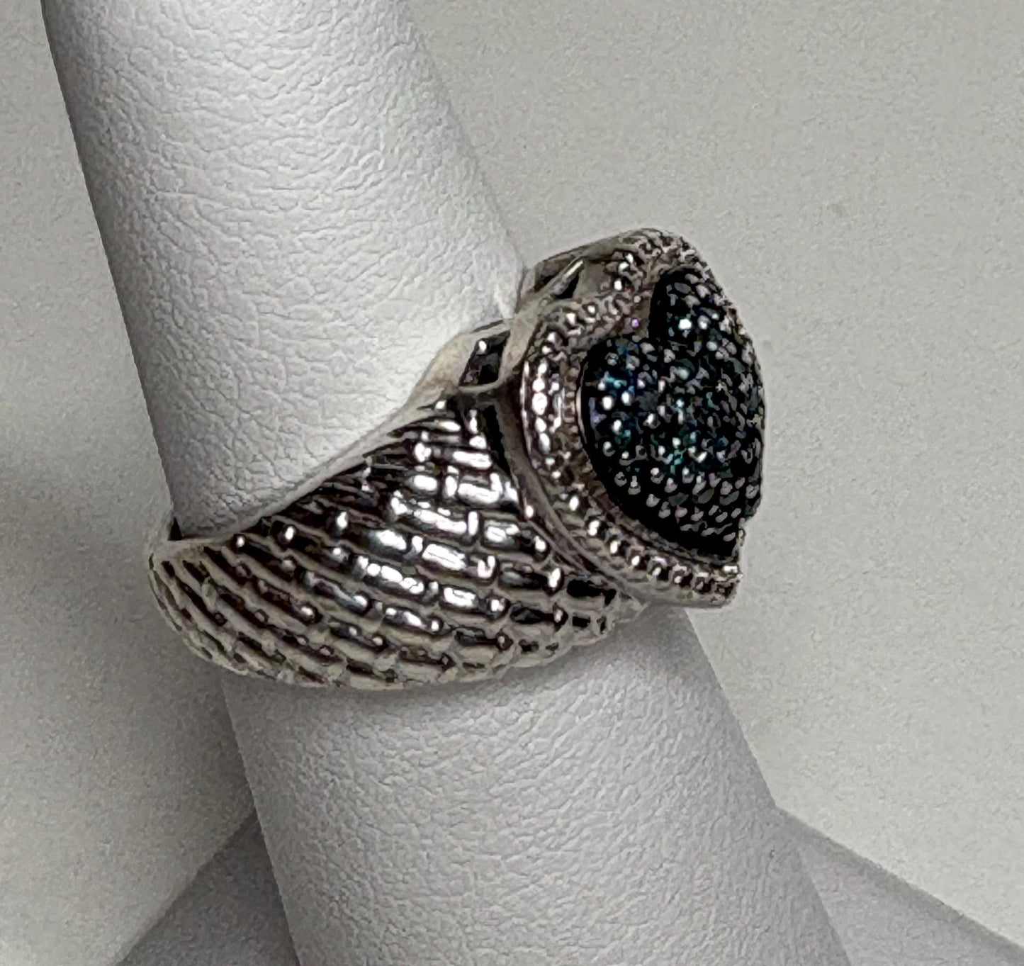 Sterling silver ring with a blue diamond pave heart and quilted band.