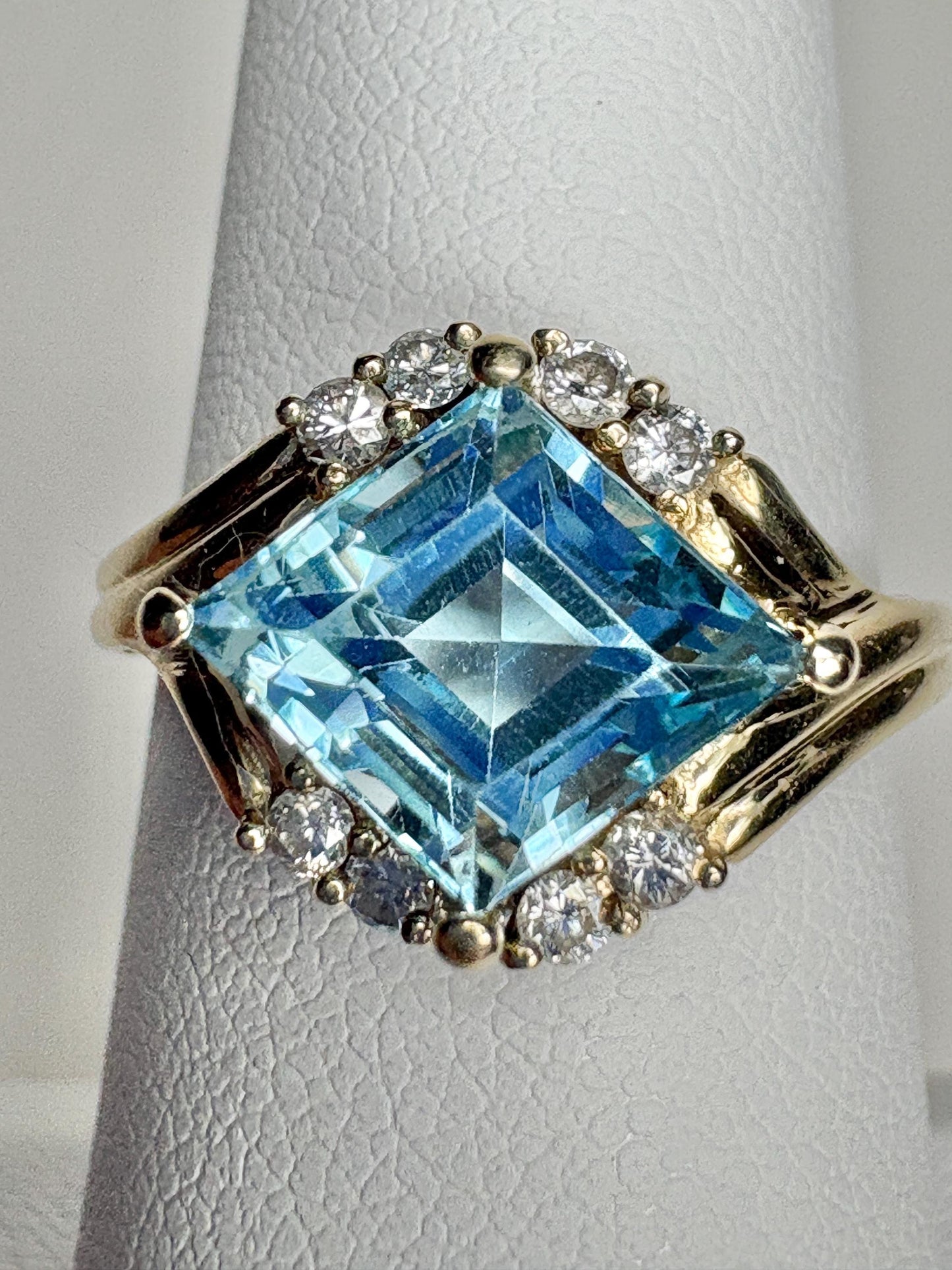 14k gold ring with a blue topaz and diamonds.