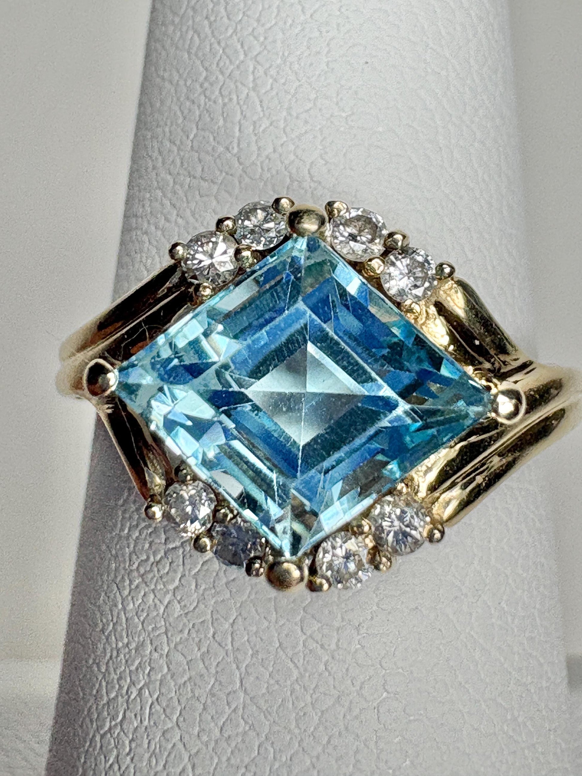 14k gold ring with a blue topaz and diamonds.