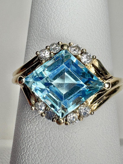 14k gold ring with a blue topaz and diamonds.