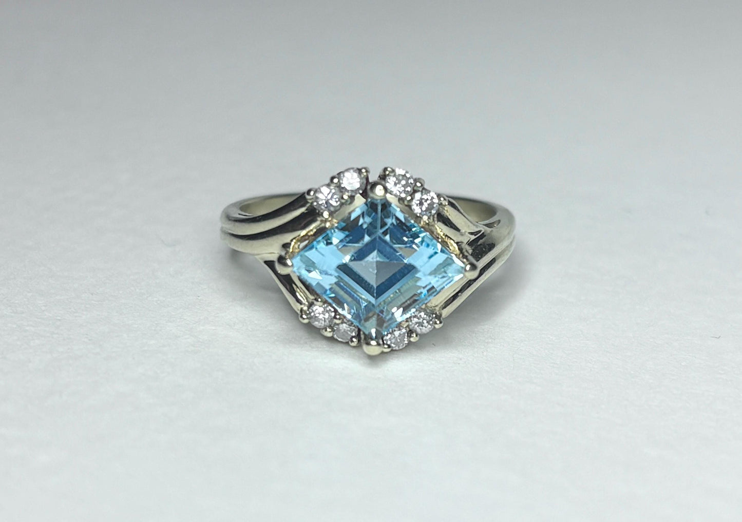 Fancy rhombus sky blue topaz and diamond ring in solid 14k gold.