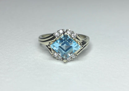 Fancy rhombus sky blue topaz and diamond ring in solid 14k gold.