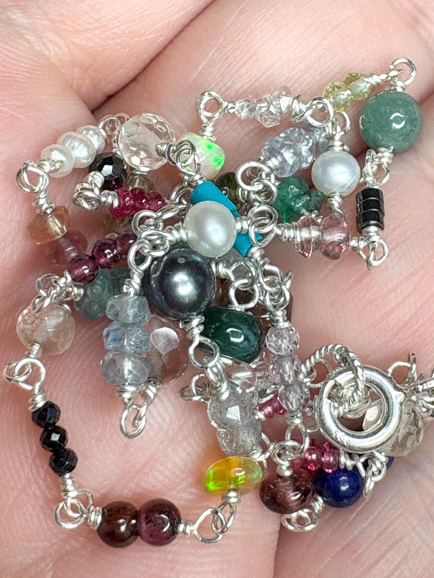 Sterling silver necklace with a variety of colorful natural gemstones.
