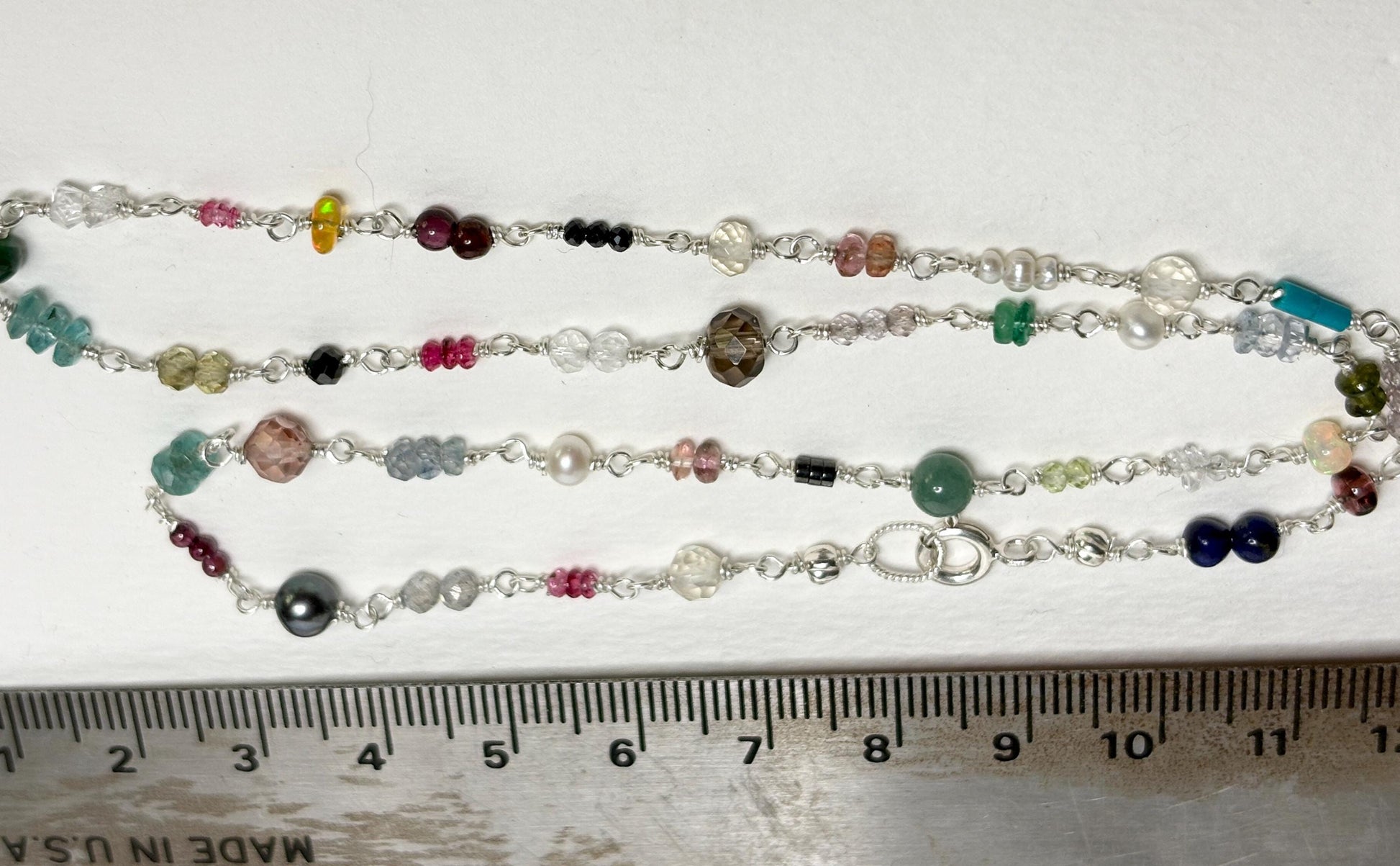Sterling silver necklace with a variety of colorful natural gemstones.