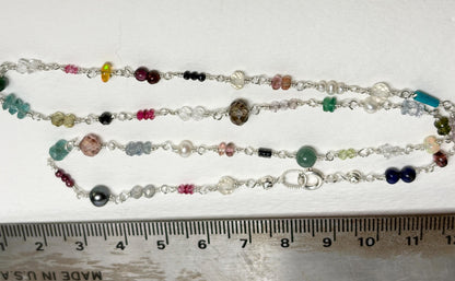 Sterling silver necklace with a variety of colorful natural gemstones.