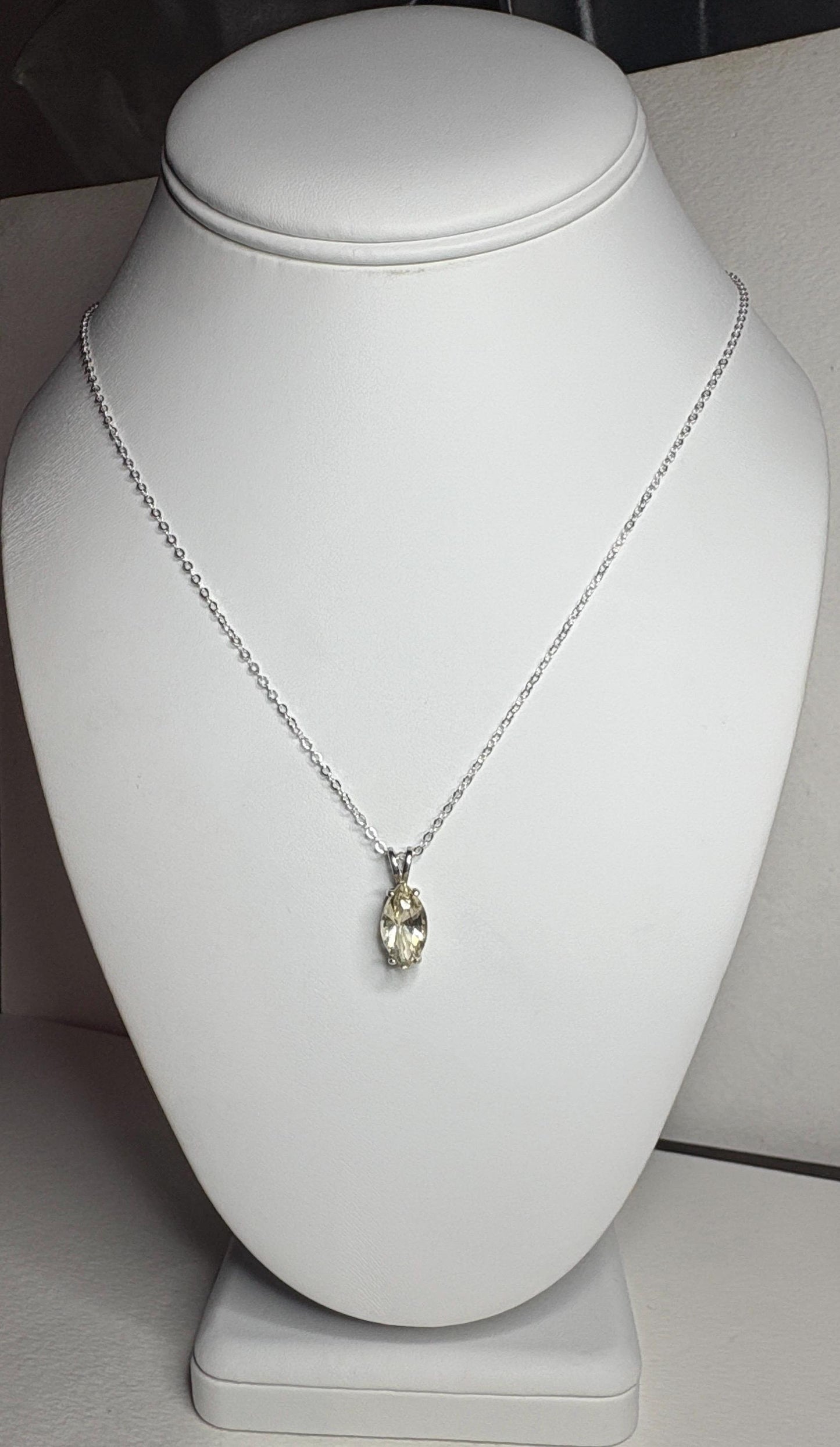 Sterling silver necklace with an 18-inch chain and a marquise-cut Oregon sunstone pendant.