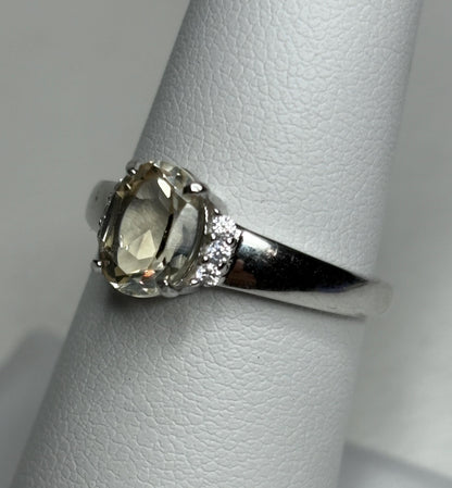 Sterling silver ring with an oval Oregon sunstone and accent crystals, size 7.