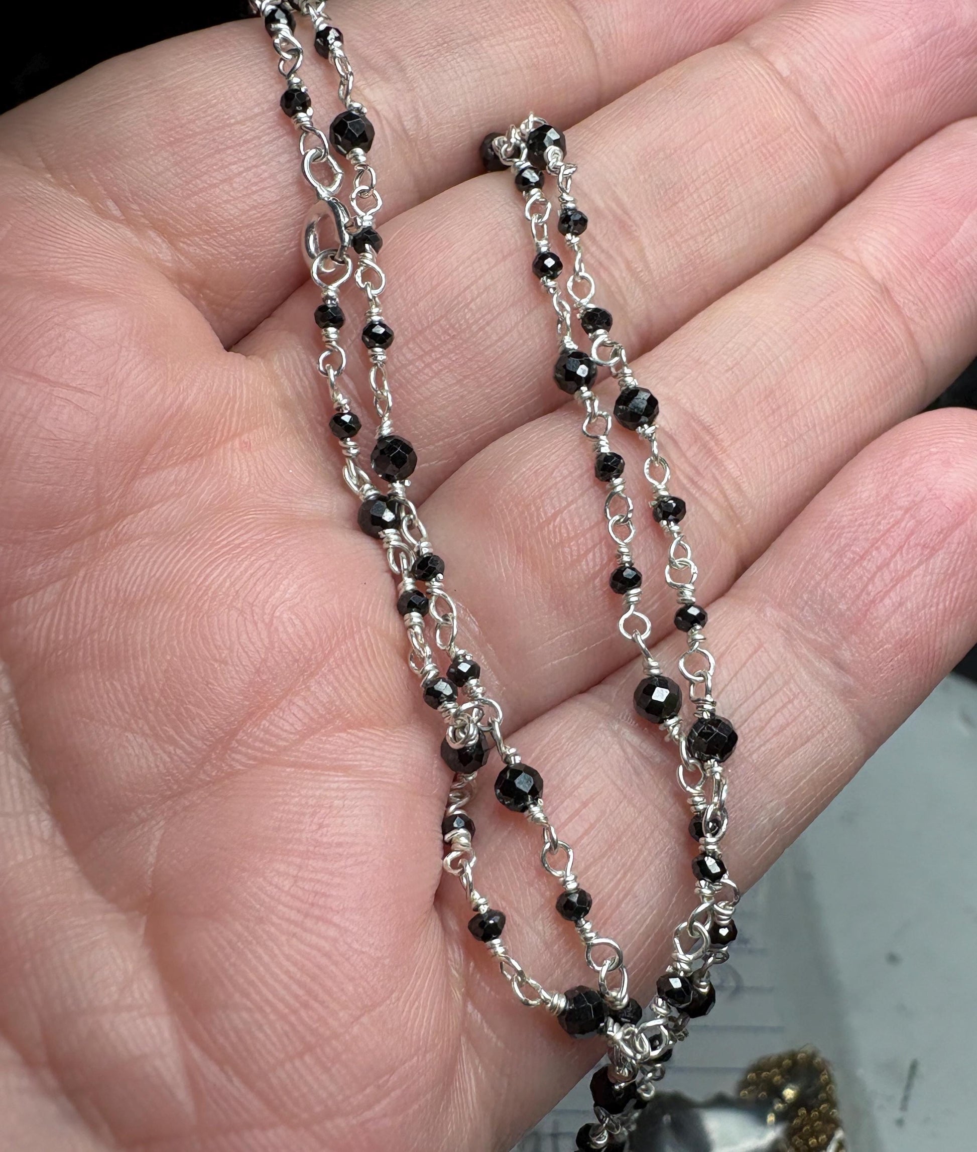 Sterling silver necklace with faceted black diamond beads.