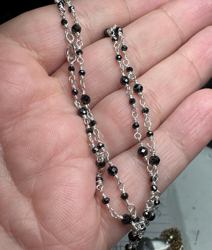 Sterling silver necklace with faceted black diamond beads.