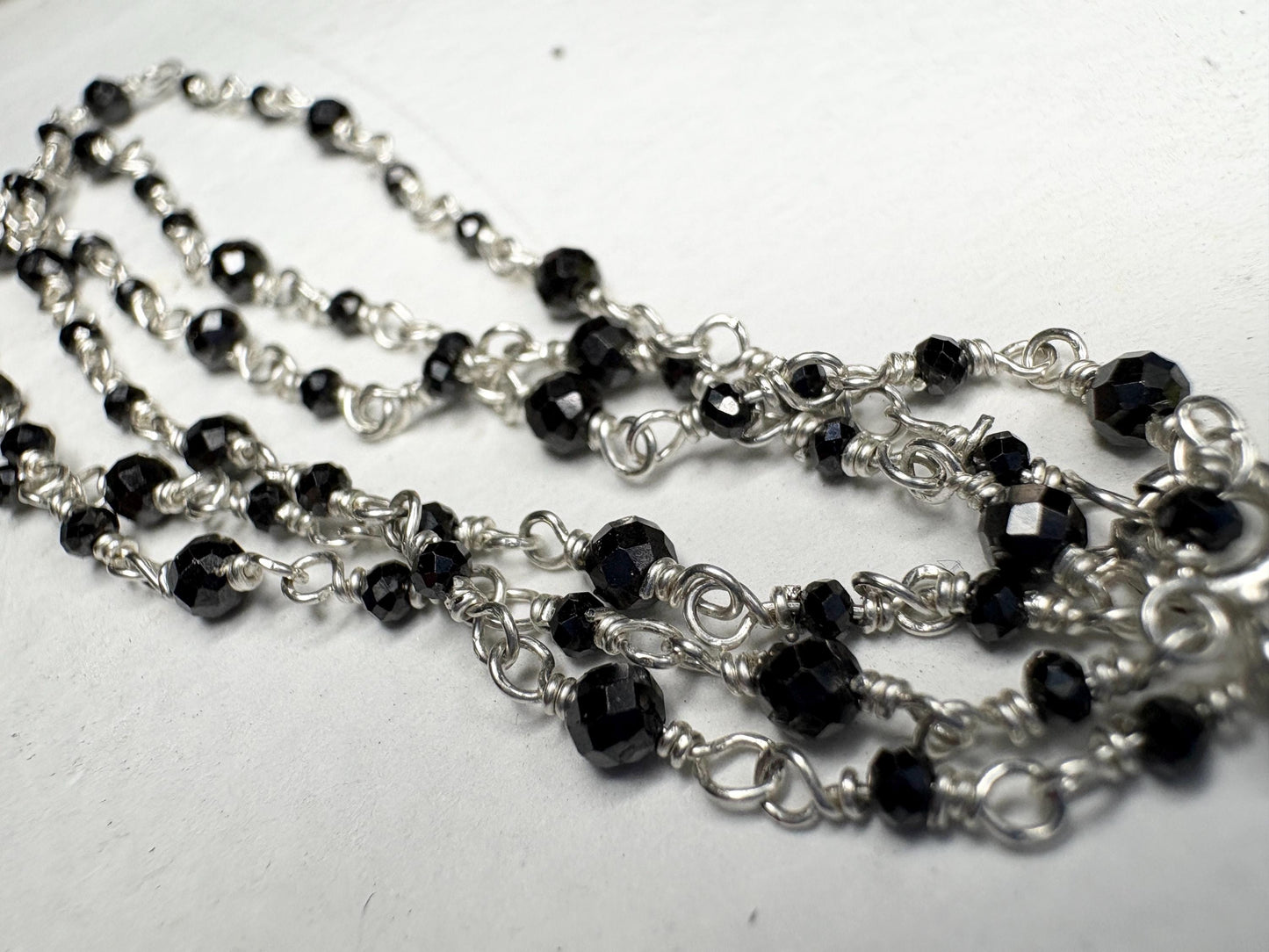 Sterling silver necklace with faceted black diamond beads.