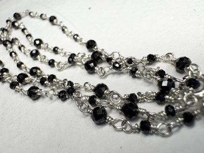 Sterling silver necklace with faceted black diamond beads.