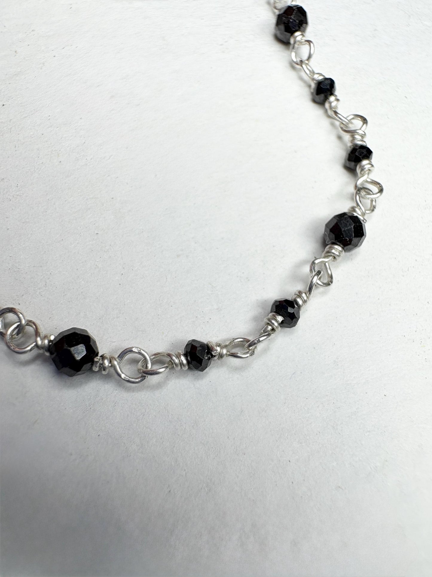 Sterling silver necklace with faceted black diamond beads.