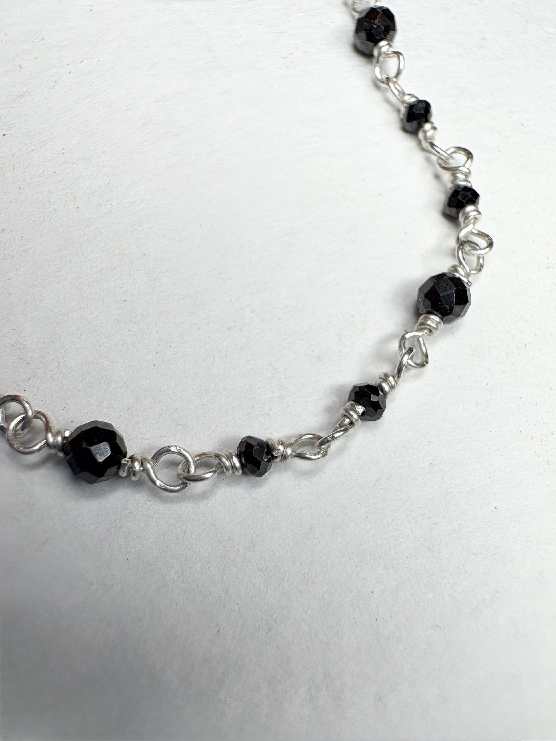 Sterling silver necklace with faceted black diamond beads.