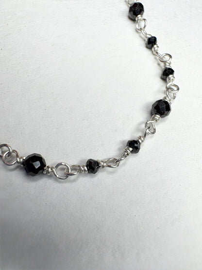 Sterling silver necklace with faceted black diamond beads.